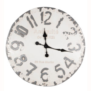 A distressed wall hanging clock with a white face and grey numbers