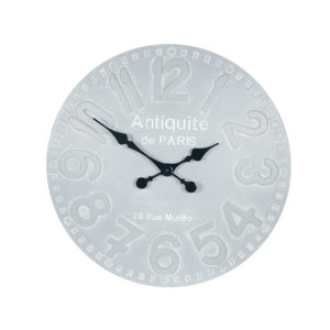A wall hanging clock in a stone grey colour. Numbers are the same colour but outlined in white so are clearly visible