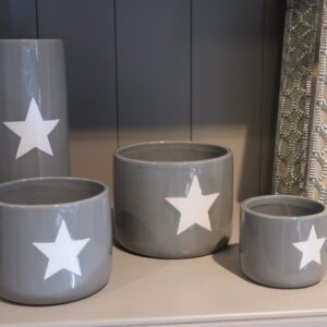 Grey ceramic plant pot with a singular white star detail to the front