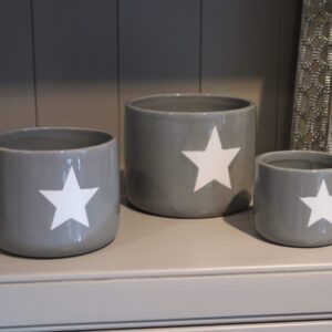 Grey ceramic plant pot with a singular white star on the front
